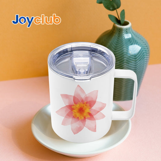 Floral decorated handled mug with a clear lid displayed beside a vase