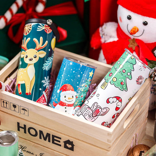 Decorated drinkware arranged in a wooden crate with festive gift props