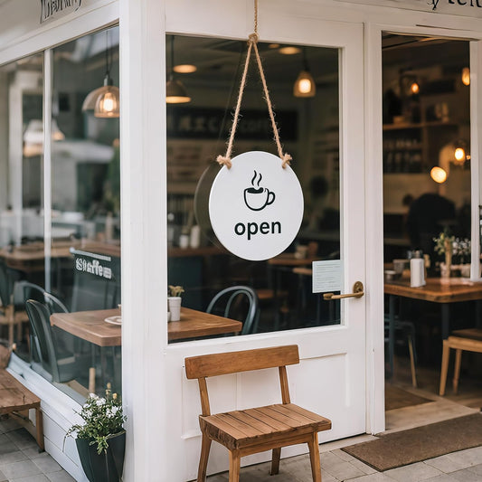 Round personalized Open sign hanging by a cord at a cafe entrance