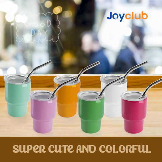 Colorful mini sublimation tumblers with lids and metal straws arranged on a wooden counter