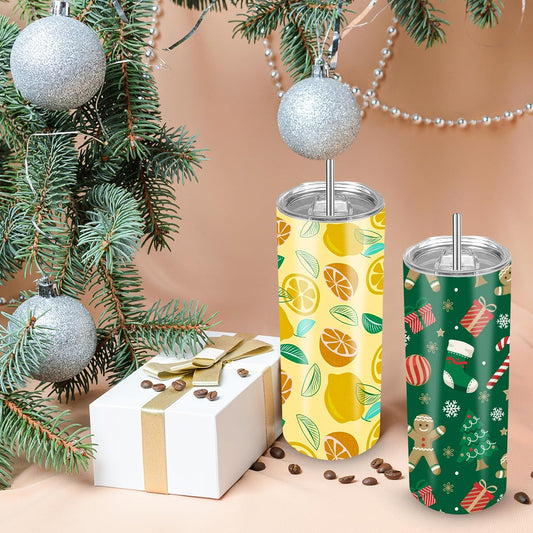Decorated 30 oz sublimation tumblers beside a wrapped gift and Christmas tree