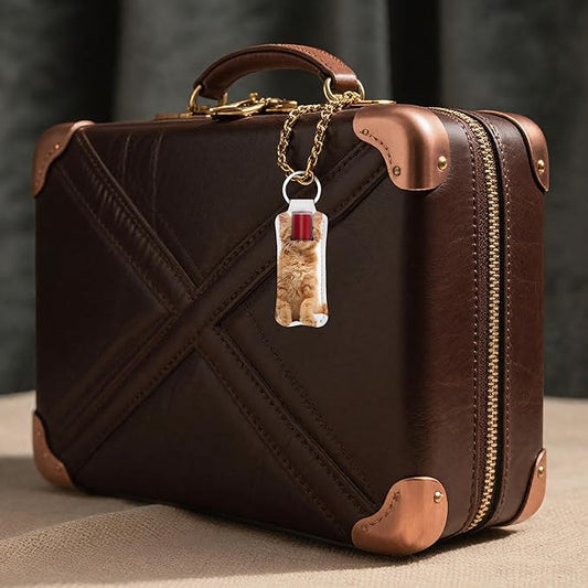Decorated lip balm holder keychain attached to a travel bag